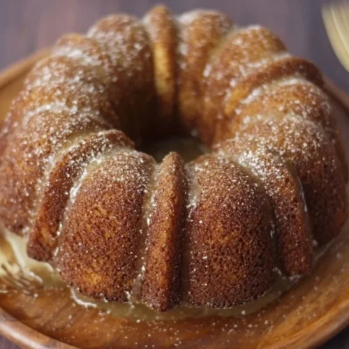 Deliciously moist Apple Cider Donut Cake topped with cinnamon and sugar