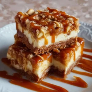 Caramel Apple Cheesecake Bars 2 Delicious caramel apple cheesecake bars with a buttery crust and apple topping.