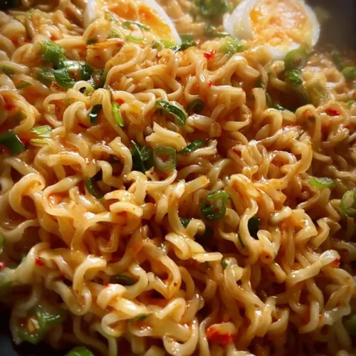Creamy Buldak Noodles 2 Creamy Buldak Noodles with spicy sauce and garnish in a bowl