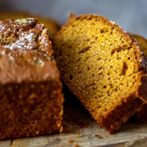 Freshly baked easy pumpkin bread recipe on a wooden table
