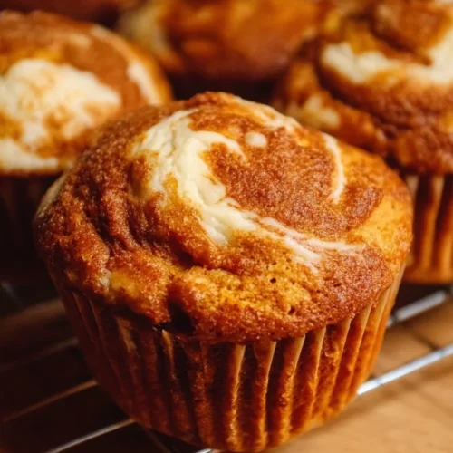 Pumpkin Cream Cheese Swirl Muffins 2 Delicious pumpkin cream cheese swirl muffins freshly baked and ready to enjoy.