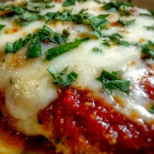Bobby Flay's Chicken Parmesan 2 Bobby Flay's delicious Chicken Parmesan served with pasta and garnished with herbs