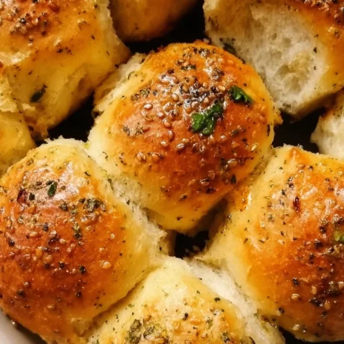 Garlic Bread Rolls 3 Freshly baked garlic bread rolls on a wooden table