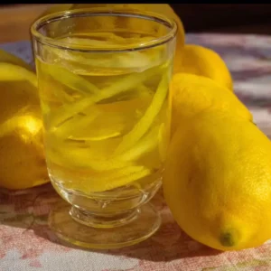 Limoncello 3 Bottle of homemade limoncello with lemon slices and herbs
