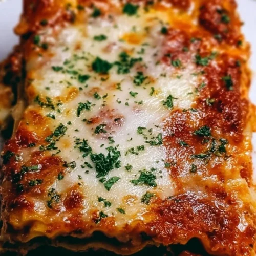 Million Dollar Lasagna 2 Delicious Million Dollar Lasagna served on a plate with fresh herbs