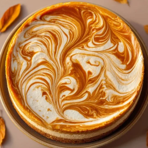 Delicious Pumpkin Swirl Cheesecake topped with creamy swirls and autumn spices
