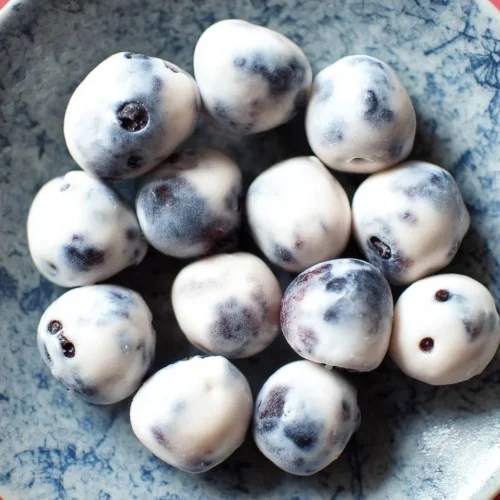 Delicious yogurt covered blueberries in a bowl