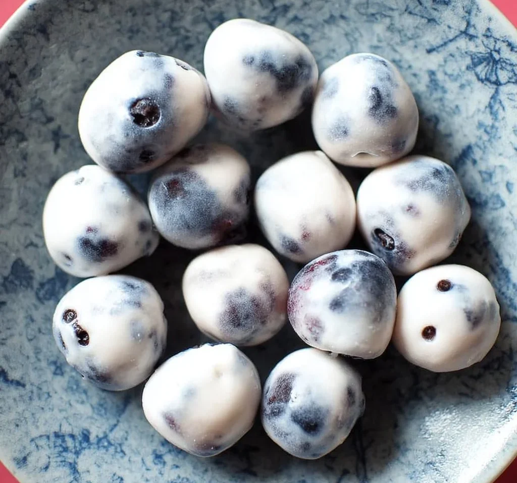 Delicious yogurt covered blueberries in a bowl