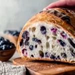 Deliciously baked blueberry sourdough bread with a golden crust and fresh blueberries.