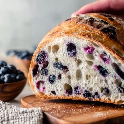 Deliciously baked blueberry sourdough bread with a golden crust and fresh blueberries.