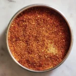 Bowl of homemade taco seasoning with spices and herbs