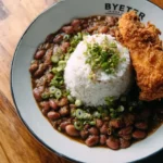 Delicious red beans and rice dish served in a bowl with herbs.