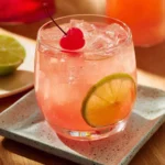 Colorful Summer Punch in a glass with fruits and ice