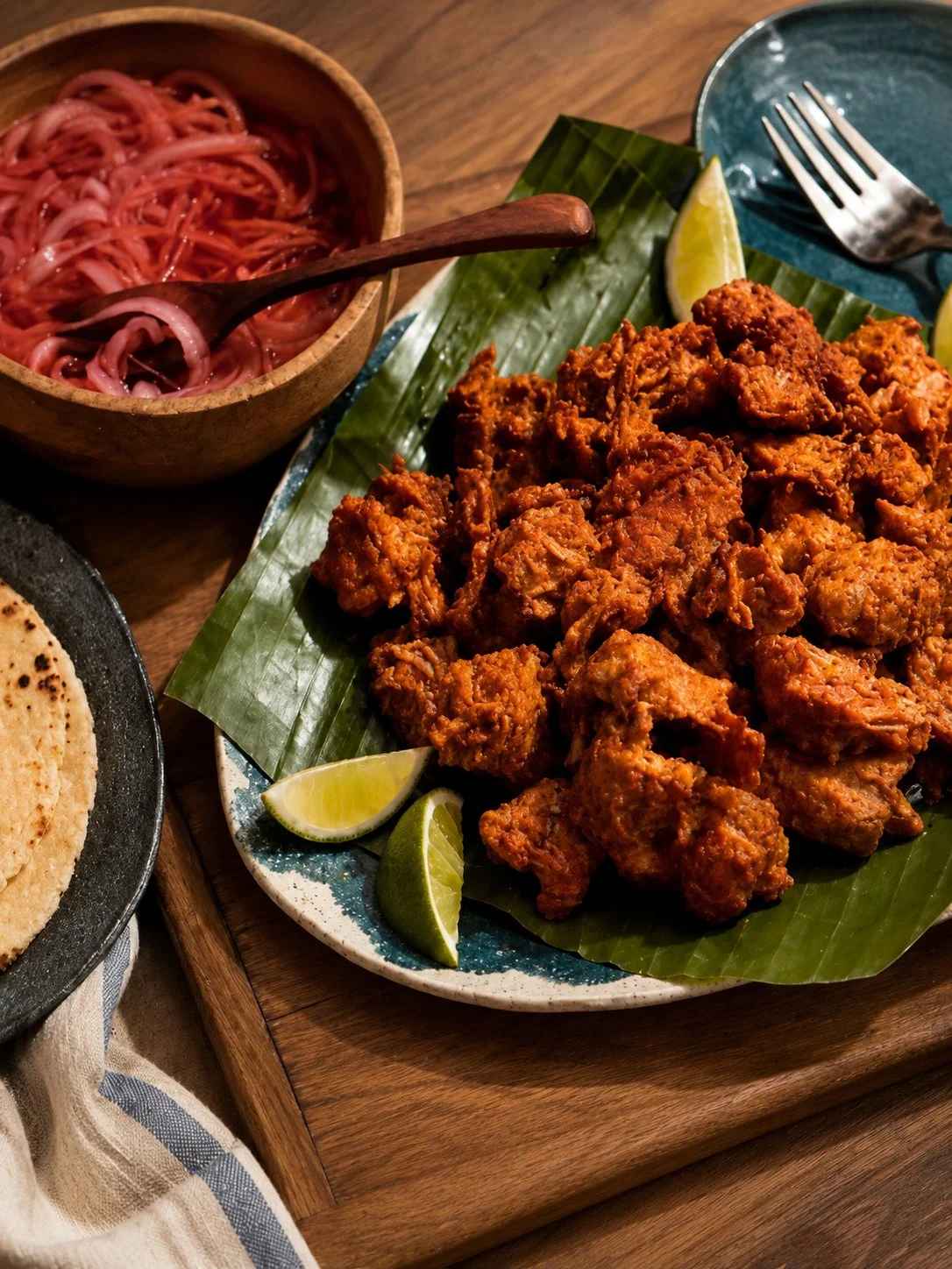 Delicious Cochinita Pibil served with pickled onions and tortillas
