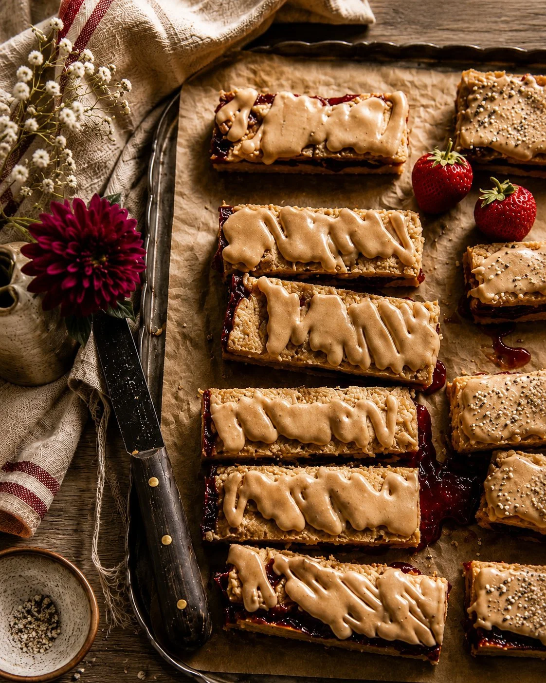 Delicious frosted strawberry brown sugar bars on a plate.