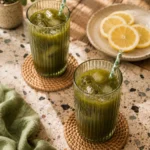 Refreshing green tea matcha lemonade in a glass with lemon slices